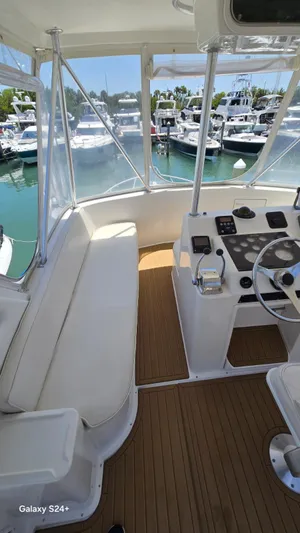  Yacht Photos Pics 1997 Ocean Yachts 40 Super Sport cockpit with marina view, featuring helm and seating area.