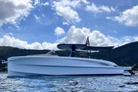 2024 Solaris Power 40 Open yacht on calm water under a cloudy sky.