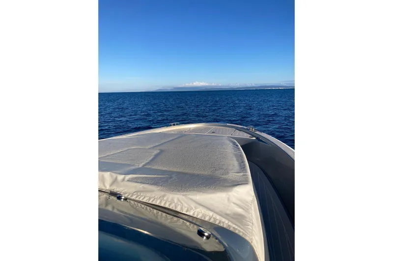  Yacht Photos Pics 2024 Solaris Power 40 Open yacht cruising on calm blue ocean waters.