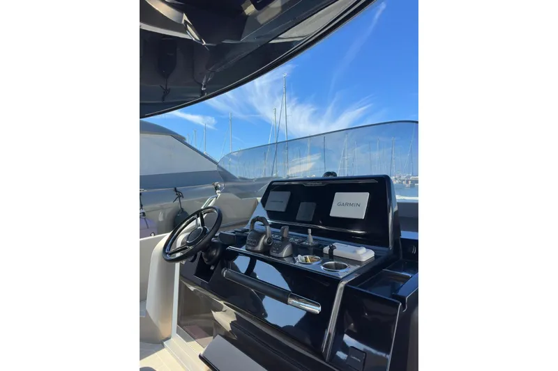  Yacht Photos Pics 2024 Solaris Power 40 Open yacht helm with Garmin navigation, sleek design, and marina backdrop.