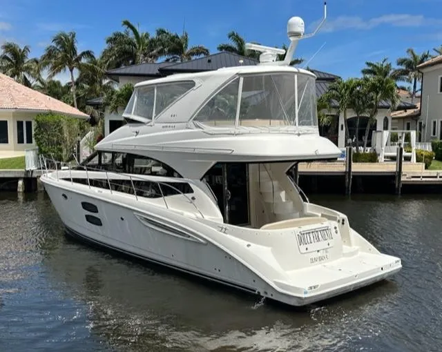 Dolce Far Niente Yacht Photos Pics 2013 Meridian 441 Sedan yacht docked in a sunny marina.