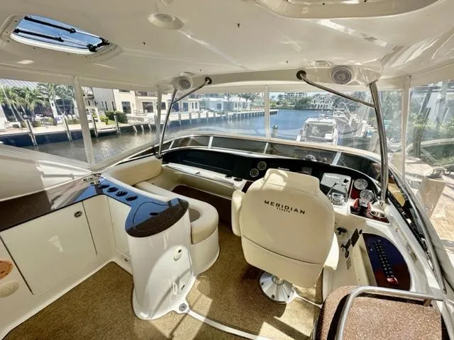 Dolce Far Niente Yacht Photos Pics Interior of a 2013 Meridian 441 Sedan yacht with helm station and waterfront view.