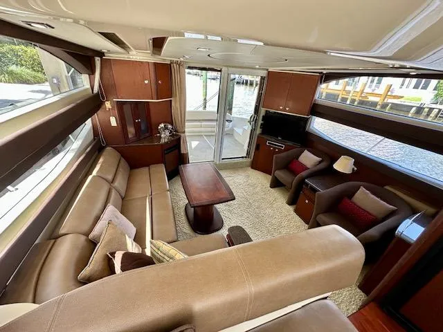 Dolce Far Niente Yacht Photos Pics Luxurious interior of a 2013 Meridian 441 Sedan yacht with leather seating and modern amenities.