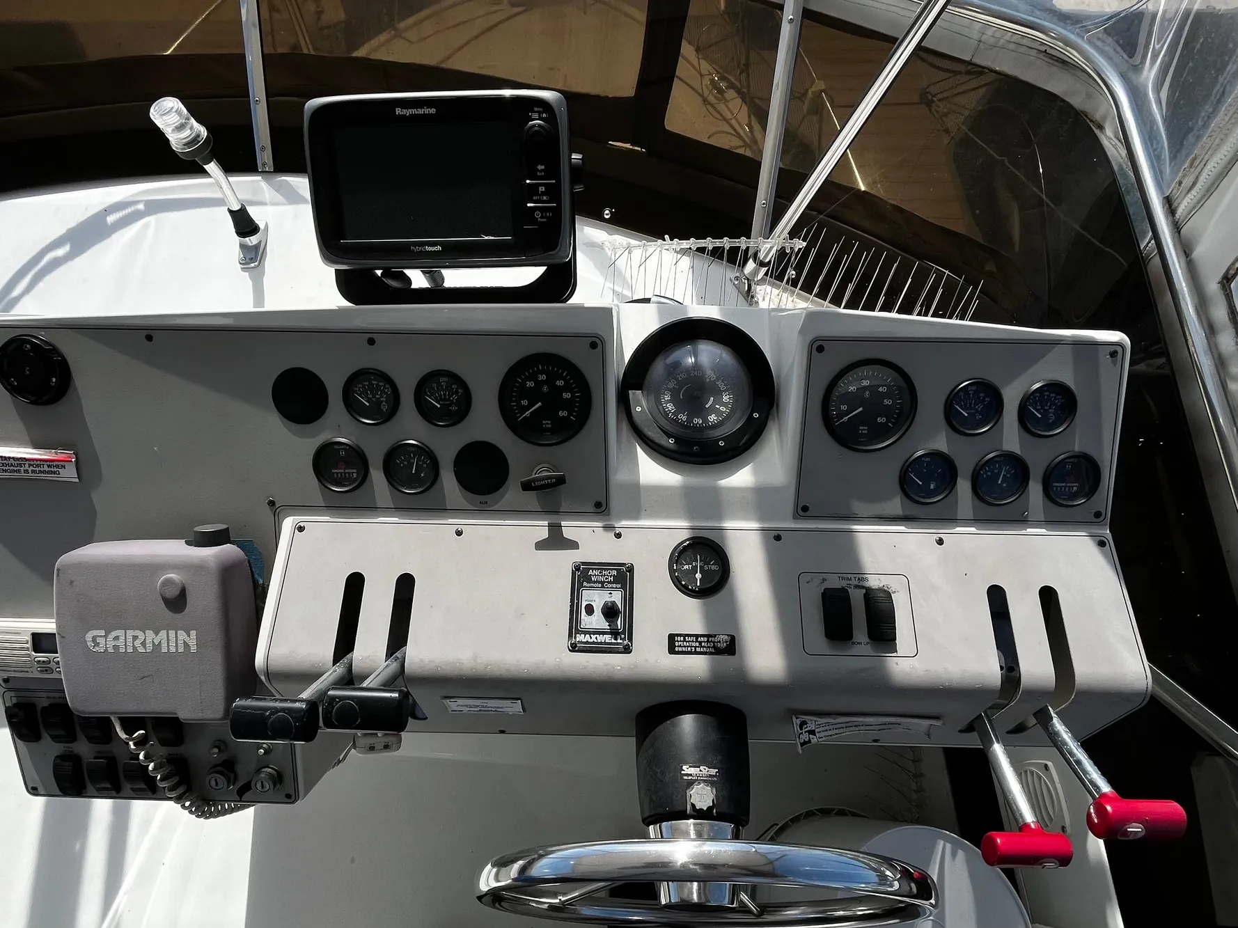1996 Carver 325 Aft Cabin helm with Garmin and Raymarine navigation systems.