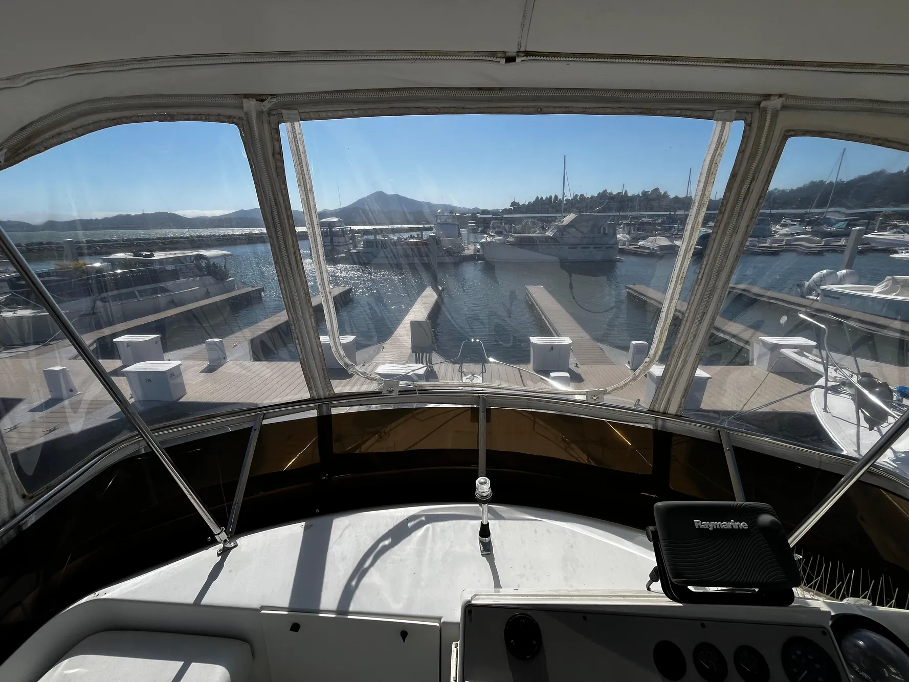 1996 Carver 325 Aft Cabin yacht view from helm, overlooking marina and docks.