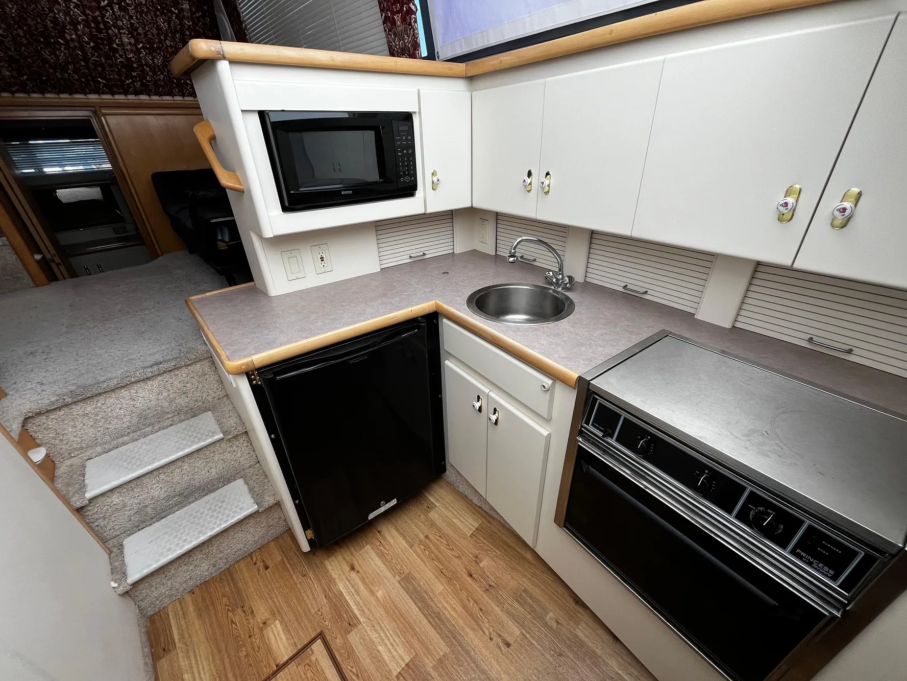 1996 Carver 325 Aft Cabin kitchen with microwave, sink, and appliances.