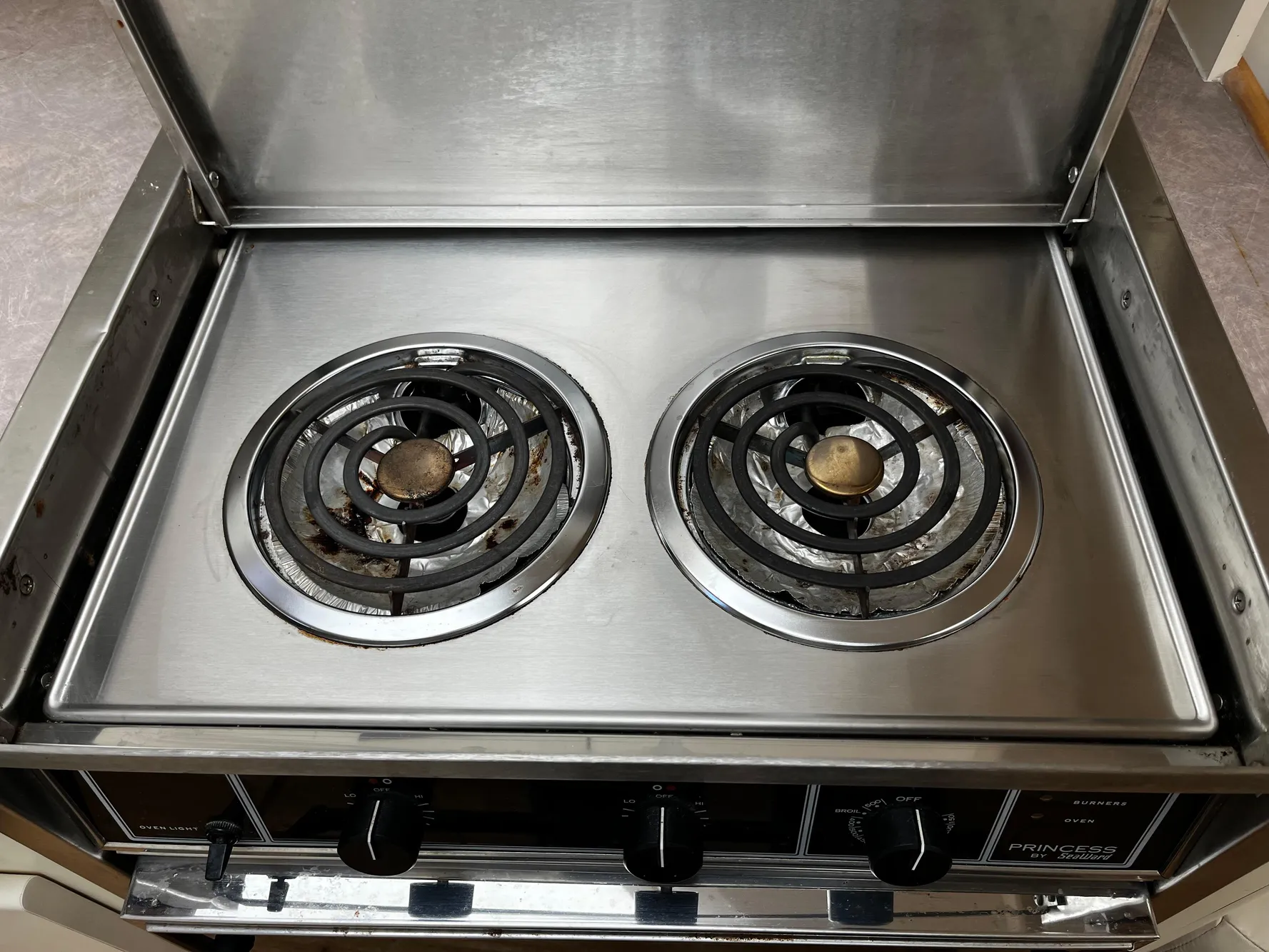 Stainless steel two-burner stove in 1996 Carver 325 Aft Cabin yacht kitchen.
