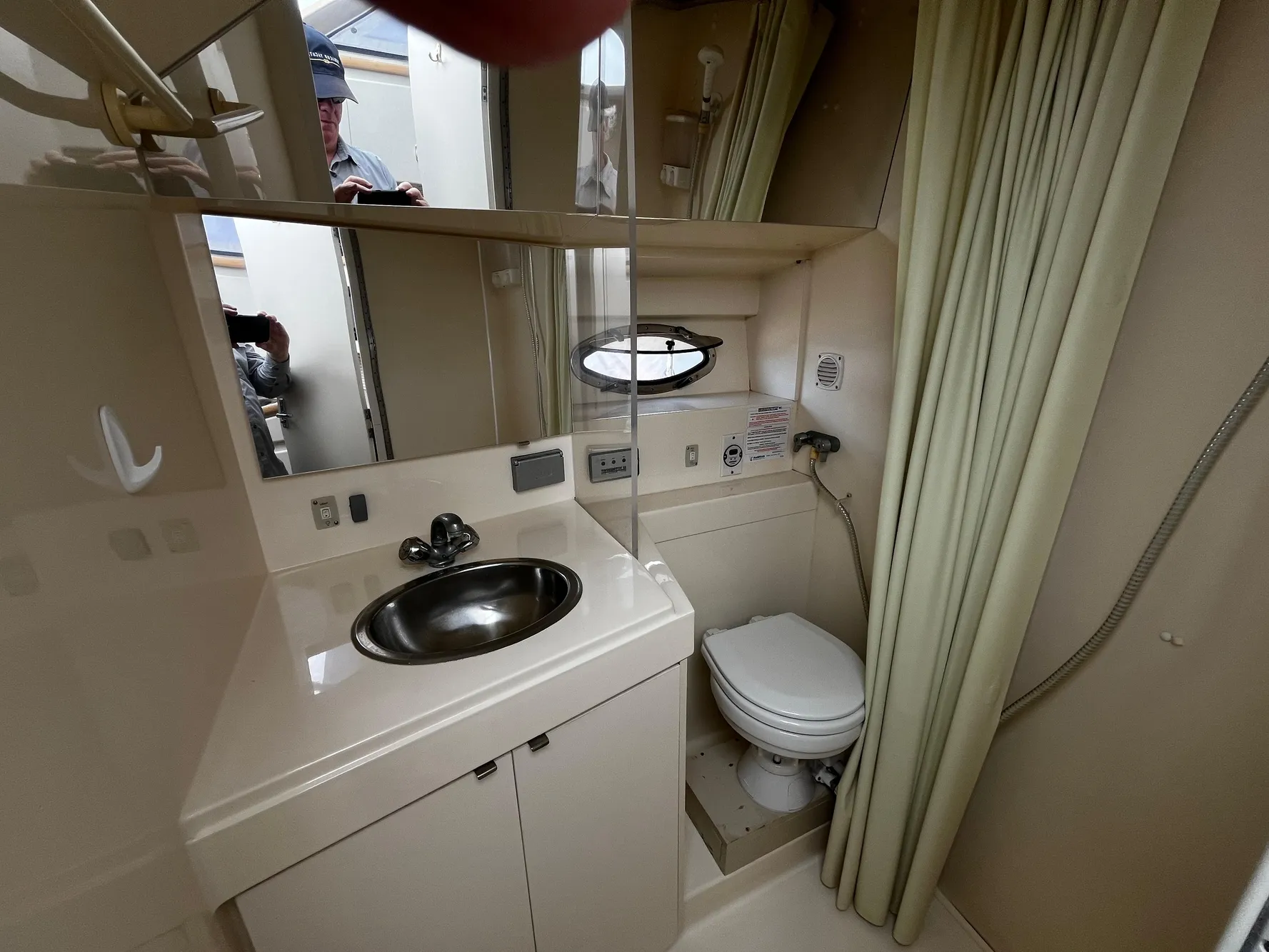 Bathroom interior of 1996 Carver 325 Aft Cabin yacht, featuring sink and toilet.