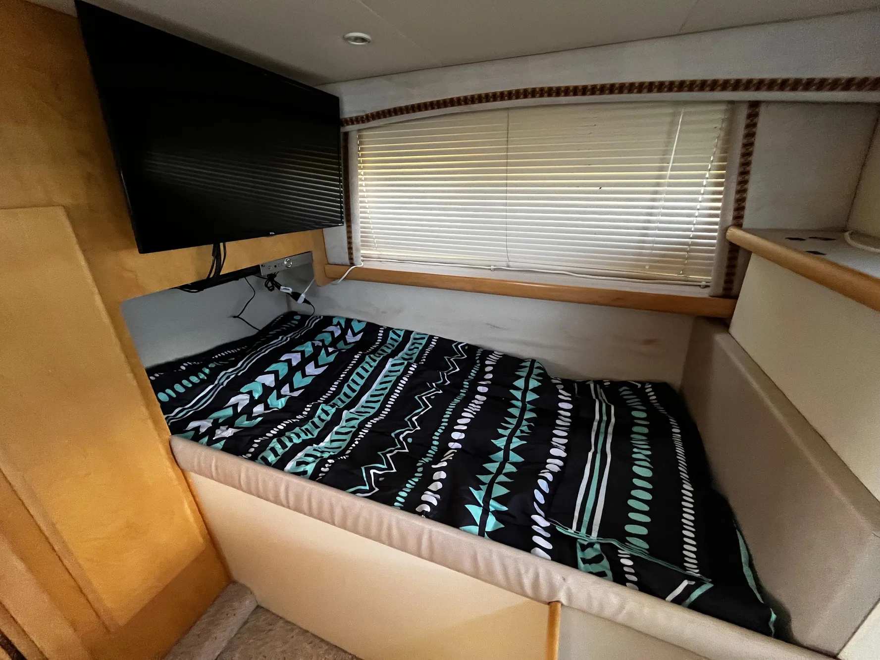 1996 Carver 325 Aft Cabin interior with bed, TV, and window blinds.