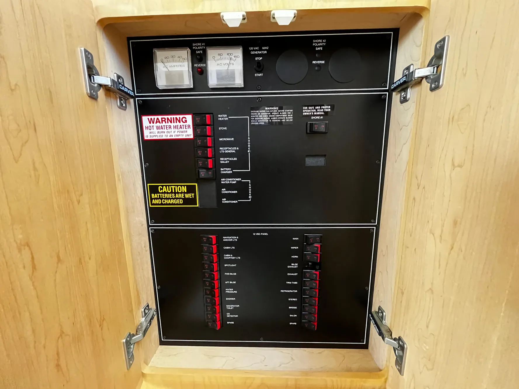 Electrical panel inside 1996 Carver 325 Aft Cabin boat, featuring switches and warning labels.