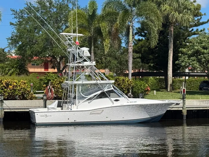 Debaitable Yacht Photos Pics 2004 Albemarle 320 Express Fisherman boat docked by lush greenery.