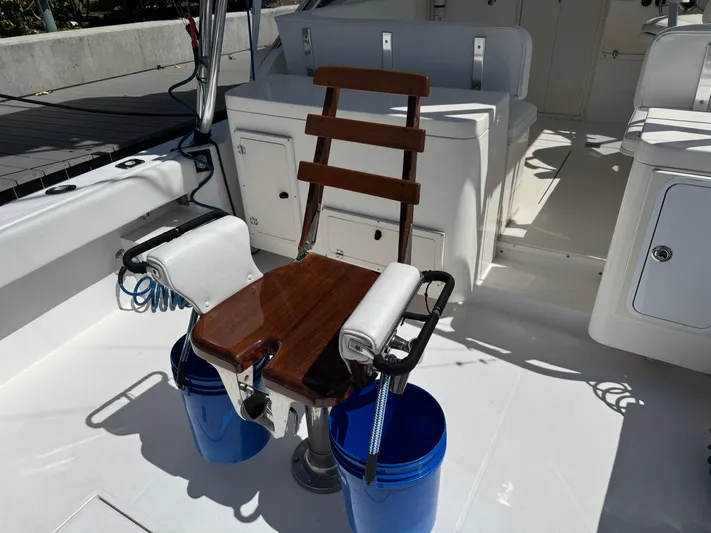 Debaitable Yacht Photos Pics 2004 Albemarle 320 Express Fisherman boat interior with fishing chair and blue buckets.