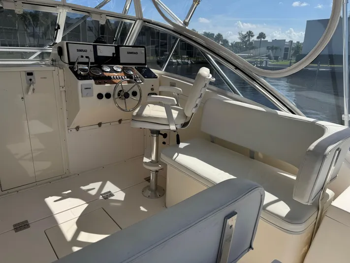 Debaitable Yacht Photos Pics 2004 Albemarle 320 Express Fisherman boat cockpit with steering wheel and seating.