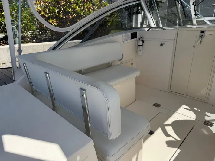 Debaitable Yacht Photos Pics 2004 Albemarle 320 Express Fisherman boat interior with white seating and control panel.