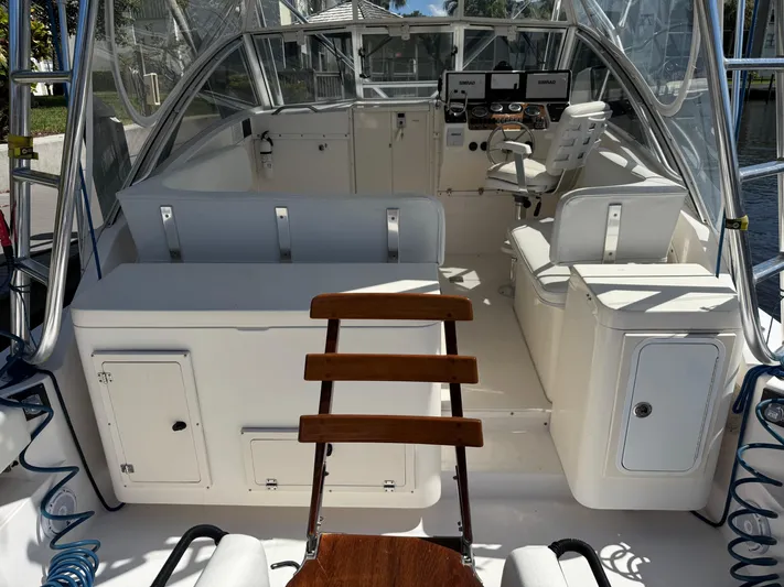 Debaitable Yacht Photos Pics 2004 Albemarle 320 Express Fisherman boat interior with helm and seating area.