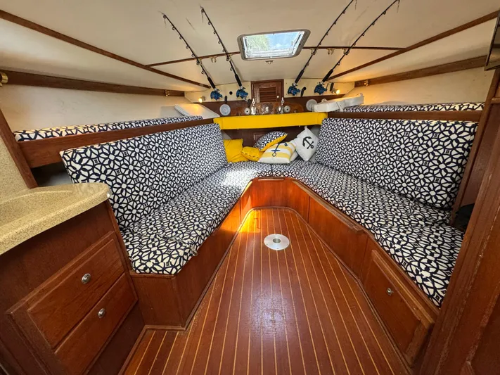 Debaitable Yacht Photos Pics Interior of 2004 Albemarle 320 Express Fisherman with patterned seating and wooden flooring.