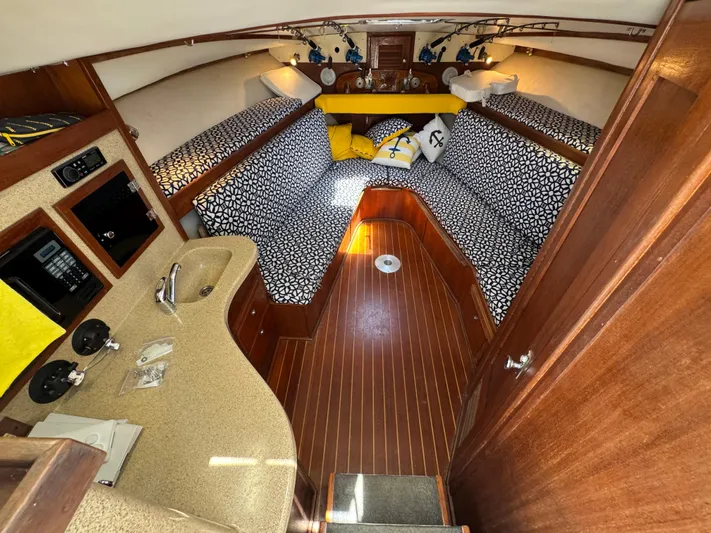 Debaitable Yacht Photos Pics 2004 Albemarle 320 Express Fisherman cabin with patterned seating and compact kitchenette.