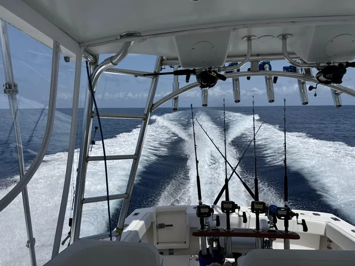 Debaitable Yacht Photos Pics 2004 Albemarle 320 Express Fisherman cruising with fishing rods, ocean view.