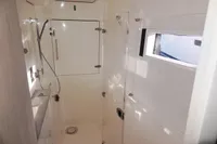 2017 Leopard 43 Powercat shower cabin with modern fixtures and natural light.
