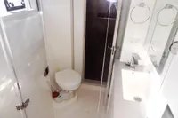 2017 Leopard 43 Powercat bathroom with toilet, sink, and shower.
