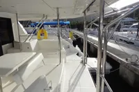 2017 Leopard 43 Powercat yacht docked at marina, featuring spacious deck and seating area.