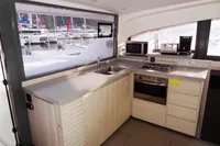 Modern kitchen in 2017 Leopard 43 Powercat yacht with appliances and marina view.