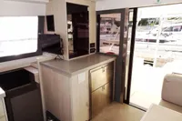 Interior of 2017 Leopard 43 Powercat yacht with modern cabinetry and marina view.
