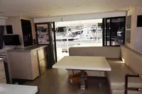 Interior of 2017 Leopard 43 Powercat yacht with dining area and marina view.