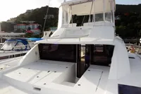 2017 Leopard 43 Powercat yacht docked at a marina with scenic hillside background.