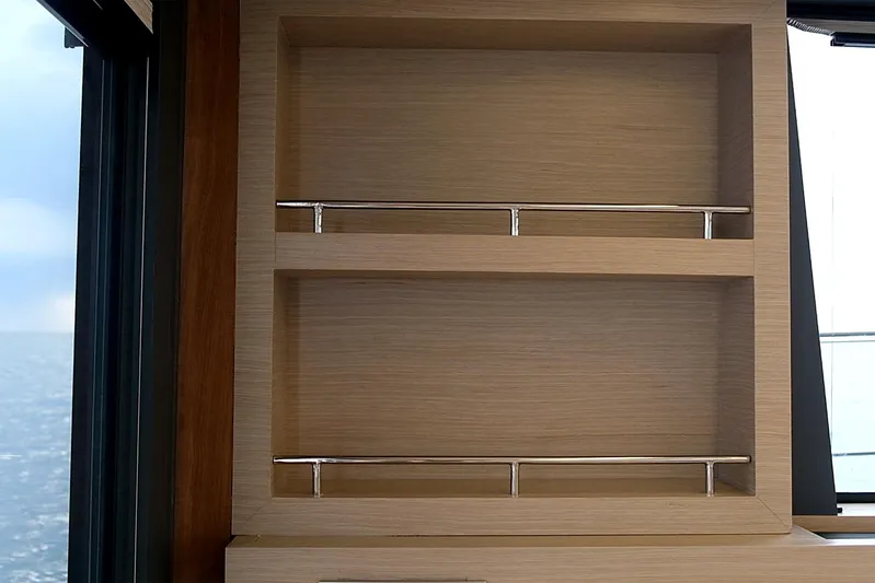  Yacht Photos Pics Wooden shelves with metal railings on a Custom DG CAT 43, 2023 model yacht interior.