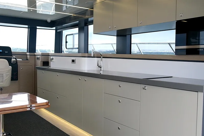  Yacht Photos Pics Modern yacht kitchen interior with sleek cabinetry, Custom DG CAT 43, 2023 model.