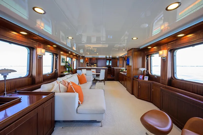 Aventurer Yacht Photos Pics Luxurious interior of 1986 Jongert 85 yacht with elegant wood paneling and plush seating.