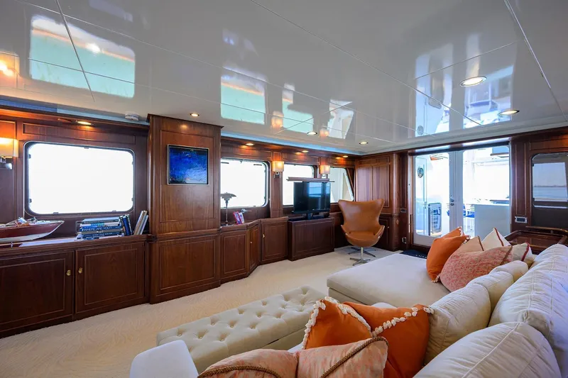 Aventurer Yacht Photos Pics Luxurious interior of 1986 Jongert 85 yacht with elegant wood paneling and plush seating.