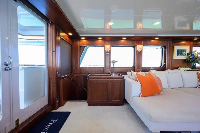 Aventurer Yacht Photos Pics Luxurious interior of 1986 Jongert 85 yacht with elegant wood paneling and plush seating.