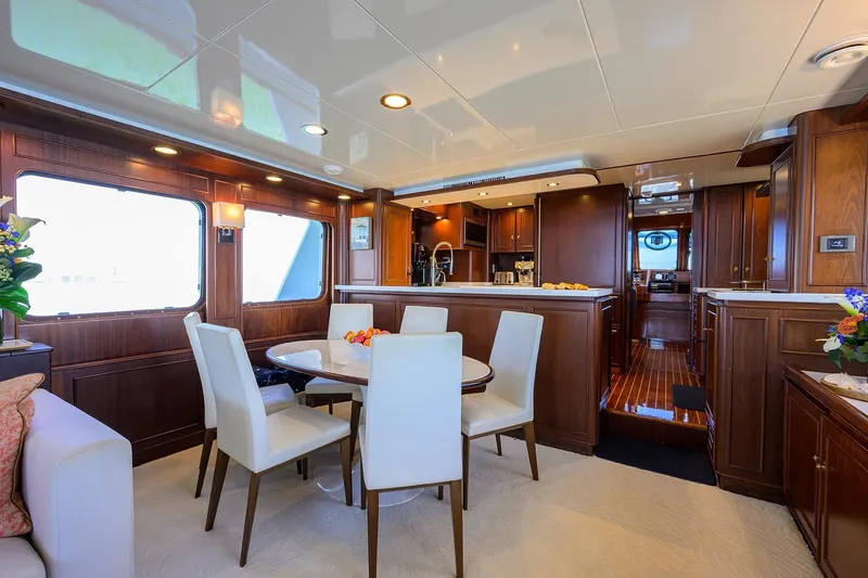 Aventurer Yacht Photos Pics Luxurious interior of 1986 Jongert 85 yacht with elegant dining area and wooden cabinetry.