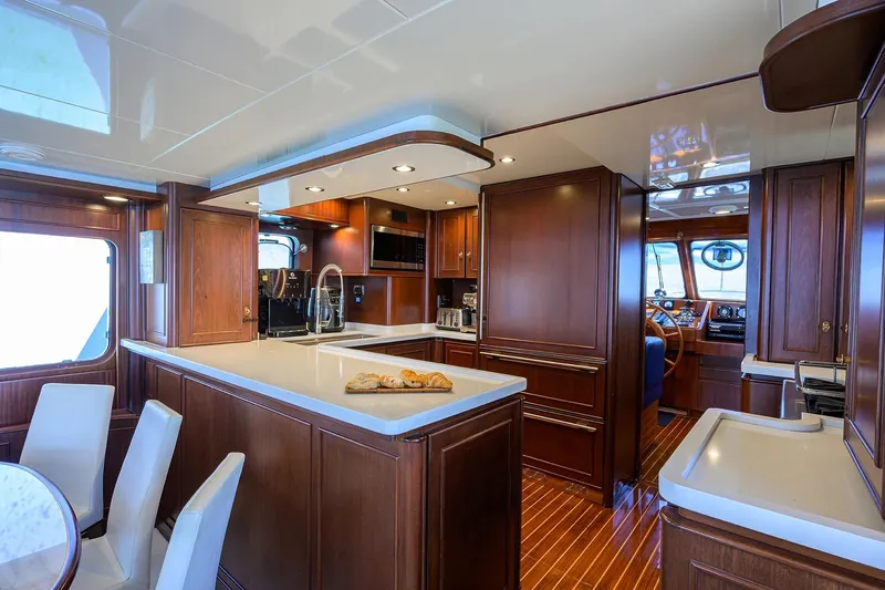 Aventurer Yacht Photos Pics Luxurious 1986 Jongert 85 yacht interior with elegant wood finishes and modern kitchen amenities.