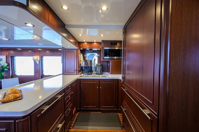 Aventurer Yacht Photos Pics Luxurious 1986 Jongert 85 yacht kitchen with elegant wood cabinetry and modern appliances.