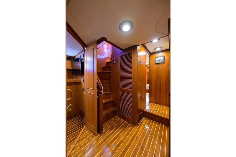 Aventurer Yacht Photos Pics Luxurious wooden interior of 1986 Jongert 85 yacht with elegant lighting and polished flooring.