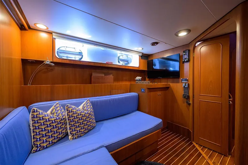 Aventurer Yacht Photos Pics Luxurious 1986 Jongert 85 yacht interior with blue seating, wooden paneling, and modern amenities.