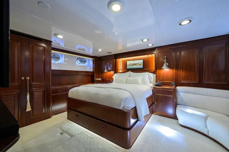 Aventurer Yacht Photos Pics Luxurious cabin interior of 1986 Jongert 85 yacht with elegant wood paneling and plush bedding.