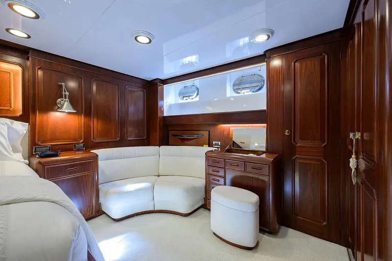 Aventurer Yacht Photos Pics Luxurious wood-paneled cabin interior of 1986 Jongert 85 yacht with elegant furnishings.