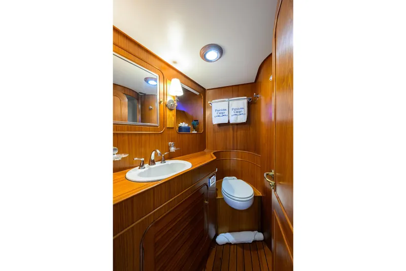 Aventurer Yacht Photos Pics Luxurious wooden bathroom interior on 1986 Jongert 85 yacht, featuring sink and toilet.