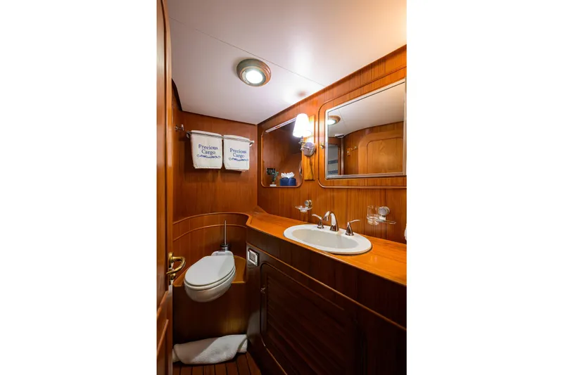 Aventurer Yacht Photos Pics Luxurious wooden bathroom interior on 1986 Jongert 85 yacht, featuring sink and mirror.