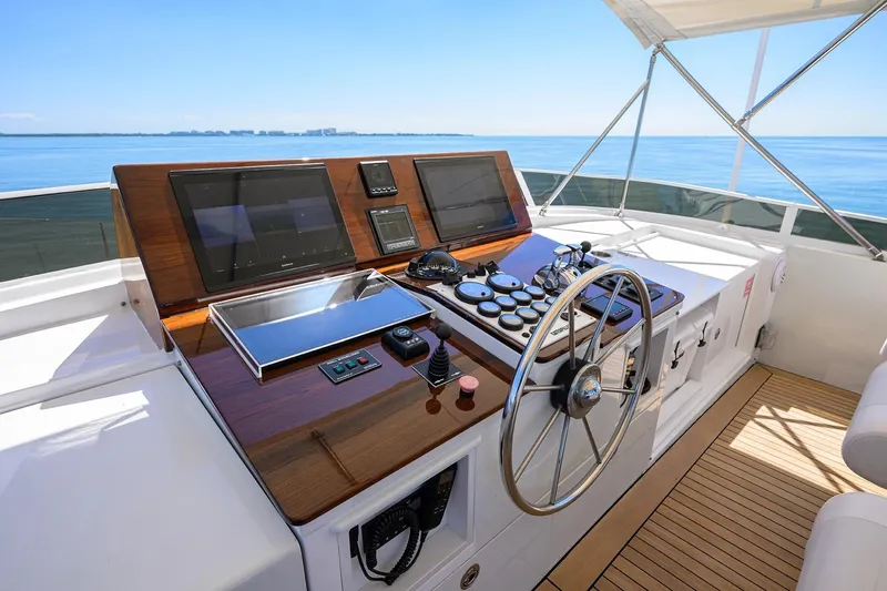 Aventurer Yacht Photos Pics Helm of 1986 Jongert 85 yacht with modern navigation equipment and wooden steering wheel.