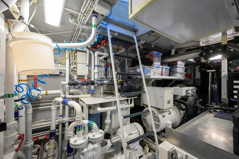 Aventurer Yacht Photos Pics Engine room of a 1986 Jongert 85 yacht, featuring complex machinery and piping systems.