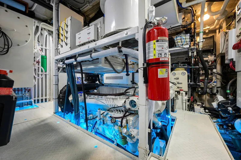 Aventurer Yacht Photos Pics Engine room of a 1986 Jongert 85 yacht, featuring machinery and fire extinguisher.