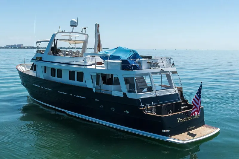 Aventurer Yacht Photos Pics 1986 Jongert 85 yacht "Precious Cargo" on calm sea with American flag.