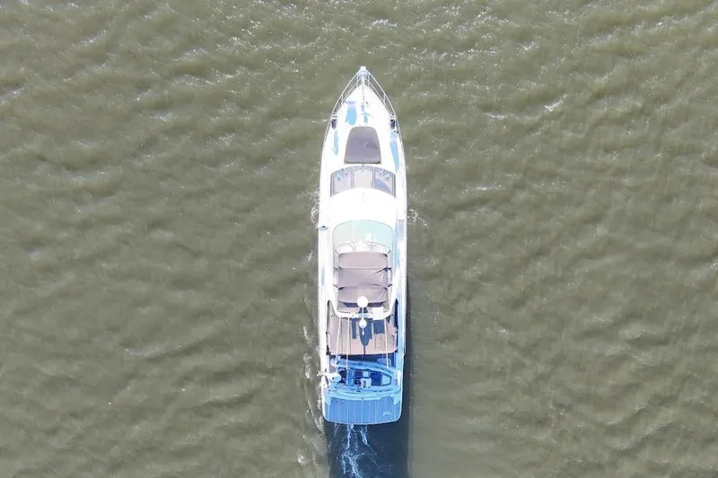 Over And Out Yacht Photos Pics Aerial view of 2001 Carver 570 Voyager Pilothouse yacht cruising on water.