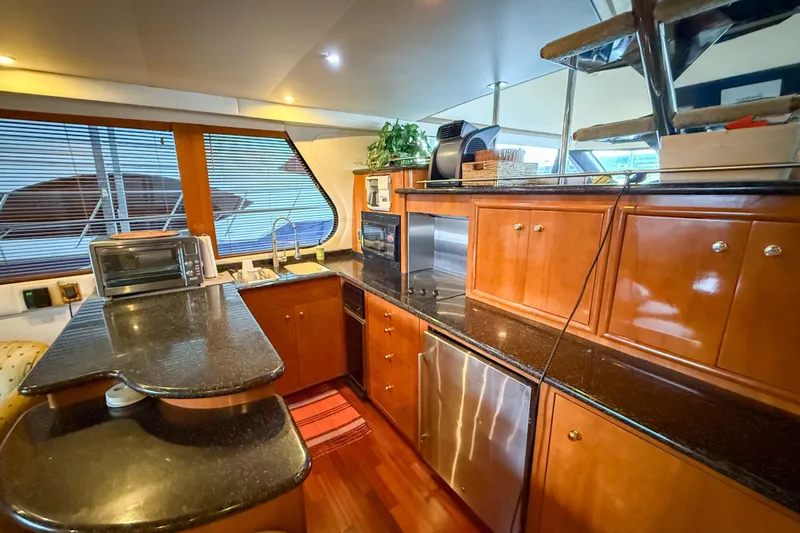 Over And Out Yacht Photos Pics Luxurious kitchen interior of 2001 Carver 570 Voyager Pilothouse yacht with modern amenities.