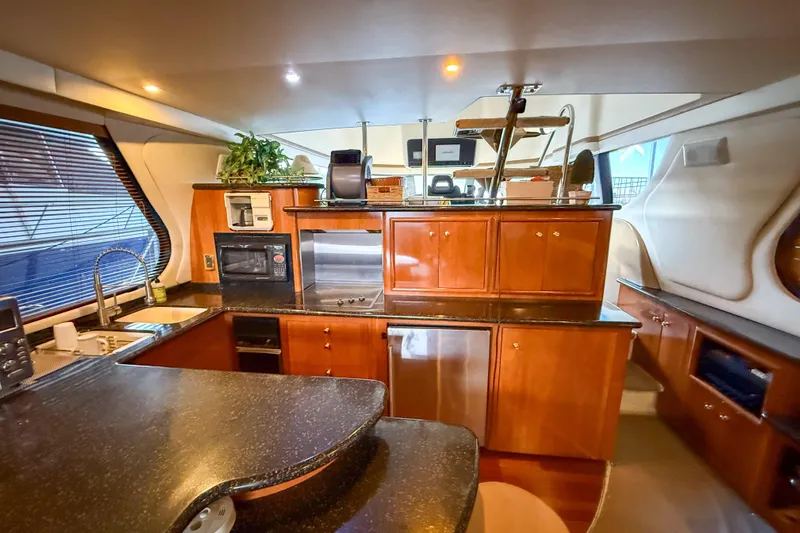 Over And Out Yacht Photos Pics Luxurious interior of 2001 Carver 570 Voyager Pilothouse yacht kitchen area.